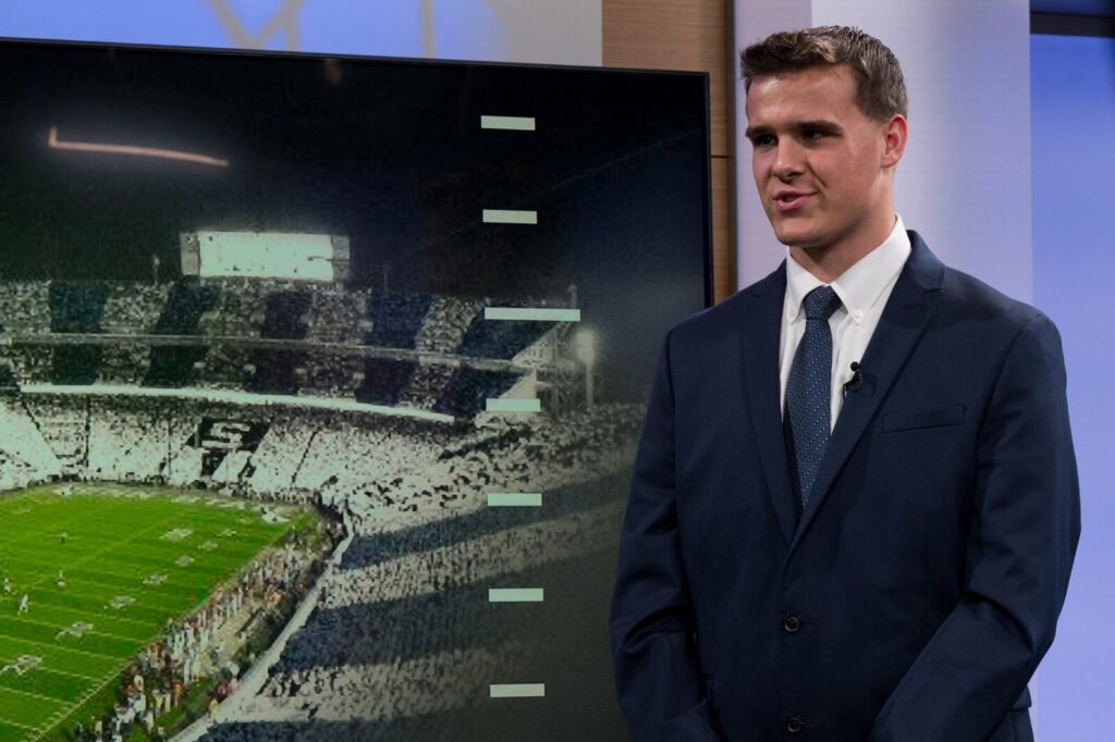 Joseph Draper reports from the studio set with Beaver Stadium on screen at Penn State