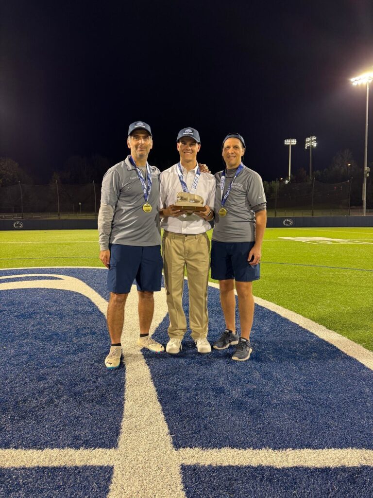 Joseph Draper holds a championship trophy after covering a conference championship